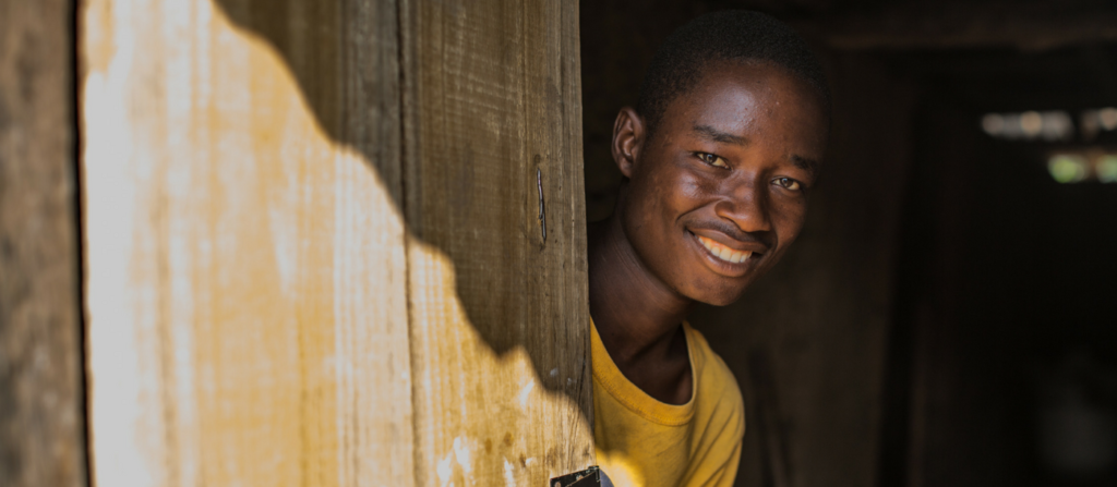 Boy in Liberia looking out home